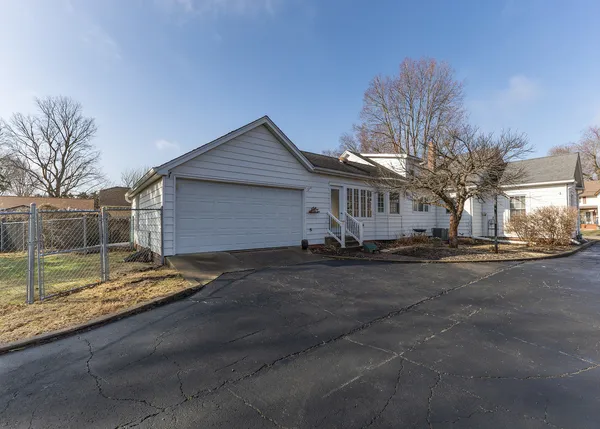 a view of a house with backyard and road