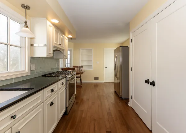 a kitchen with stainless steel appliances a stove and a refrigerator