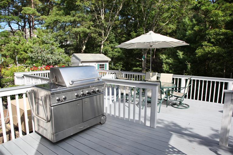 87 Cairn Ridge Road East Falmouth, MA 02536 - Photo 23 of 34 a view of a chairs and table with an umbrella in the balcony