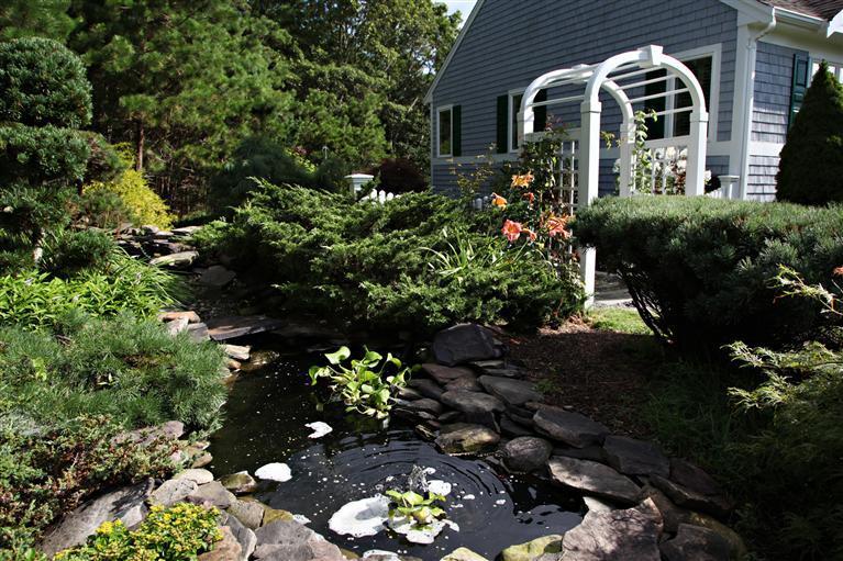 87 Cairn Ridge Road East Falmouth, MA 02536 - Photo 29 of 34 a front view of a house with a yard