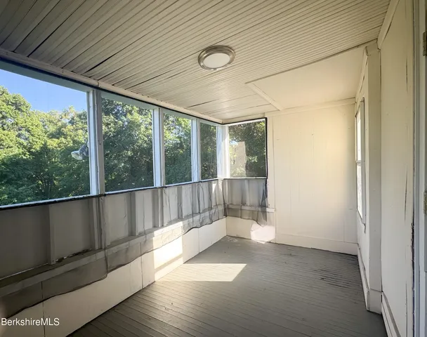 a view of outdoor space with wooden floor and windows