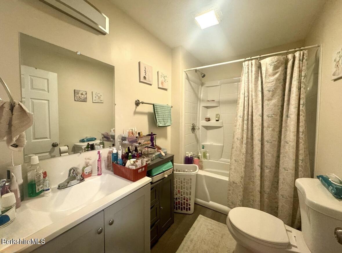 50-52 John Street Pittsfield, MA 01201 - Photo 19 of 25 a bathroom with a double vanity sink toilet mirror and shower