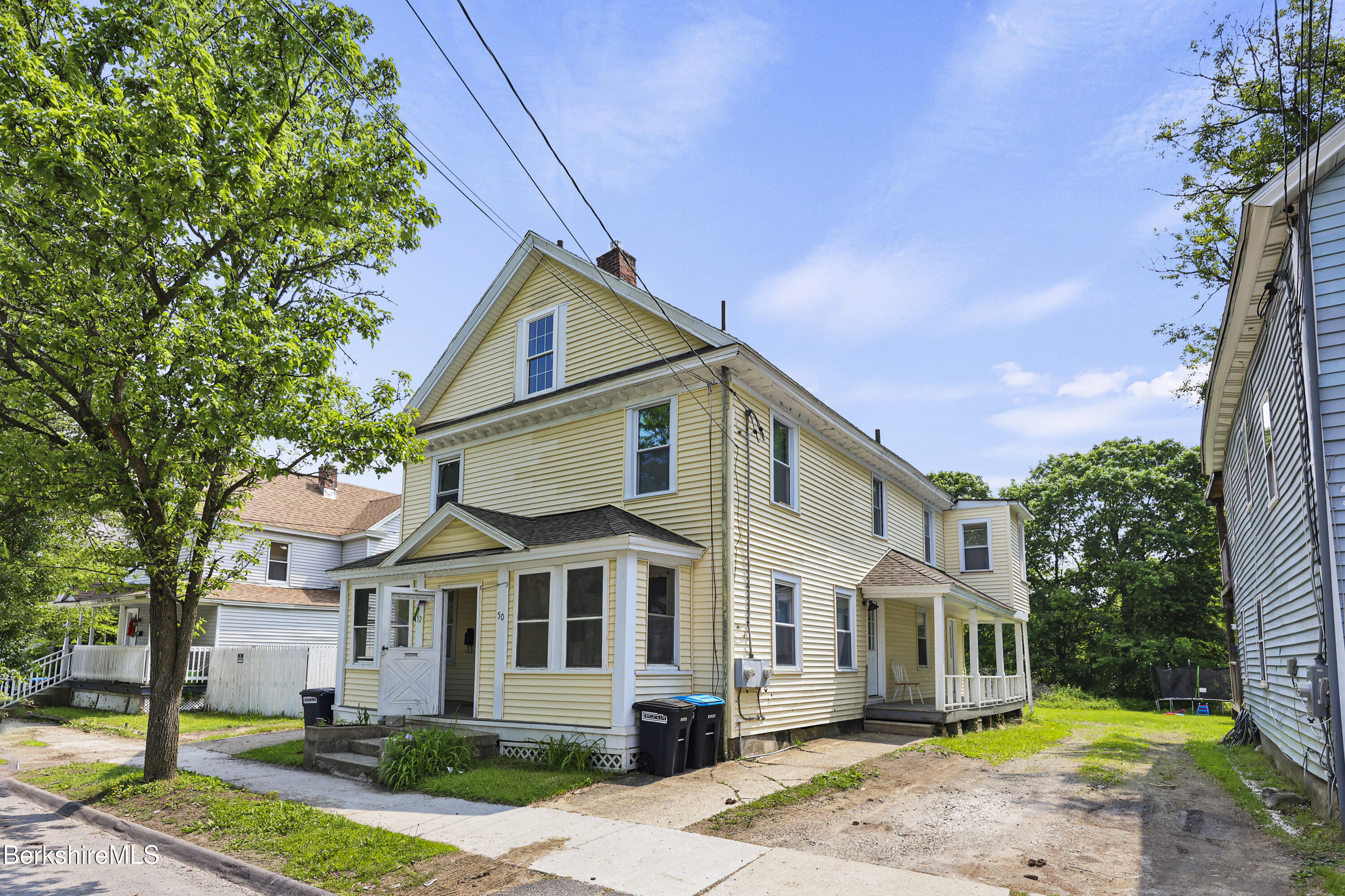 50-52 John Street Pittsfield, MA 01201 - Photo 3 of 25 a front view of a house with a garden and plants