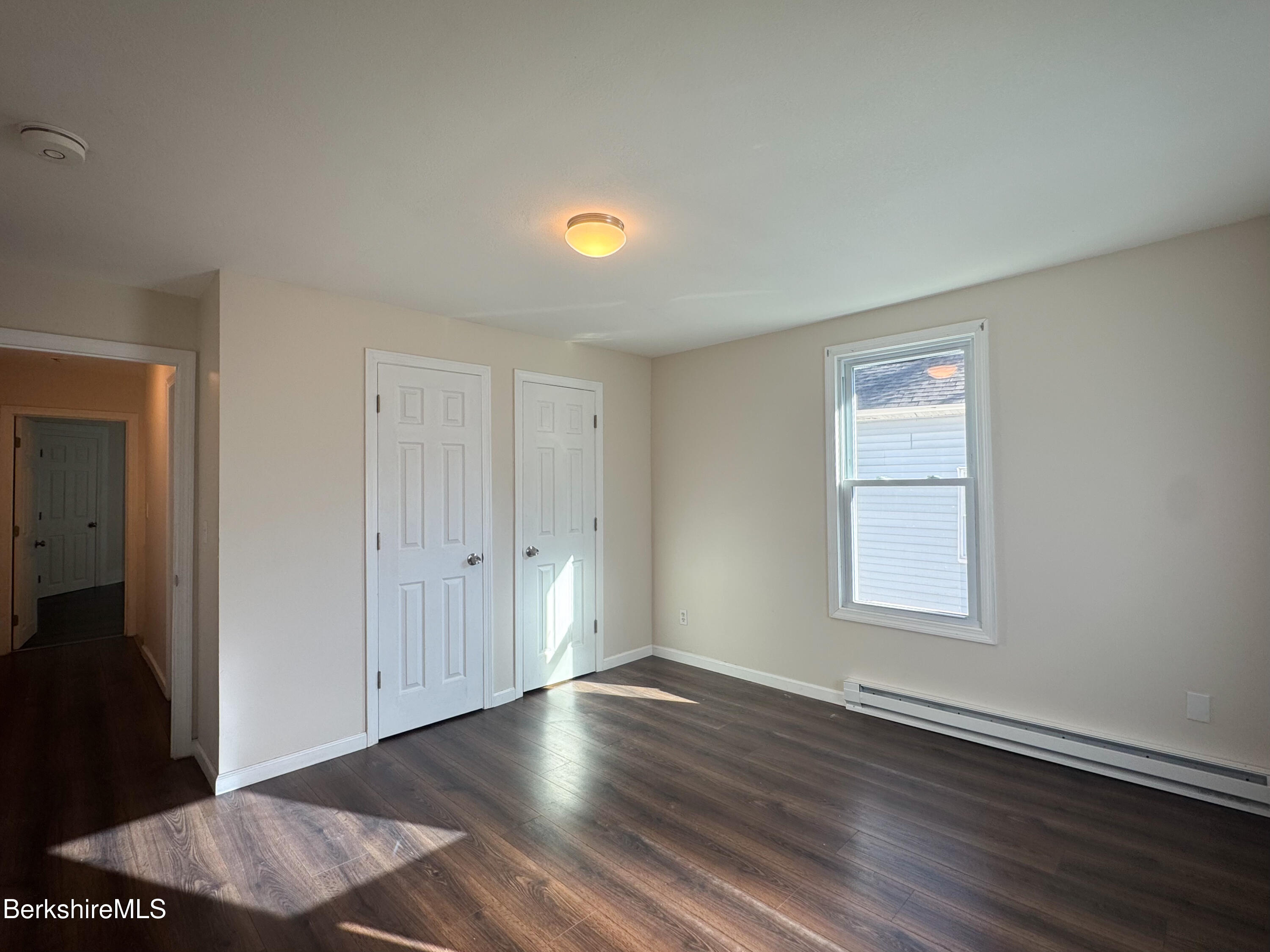 50-52 John Street Pittsfield, MA 01201 - Photo 6 of 25 an empty room with wooden floor and windows