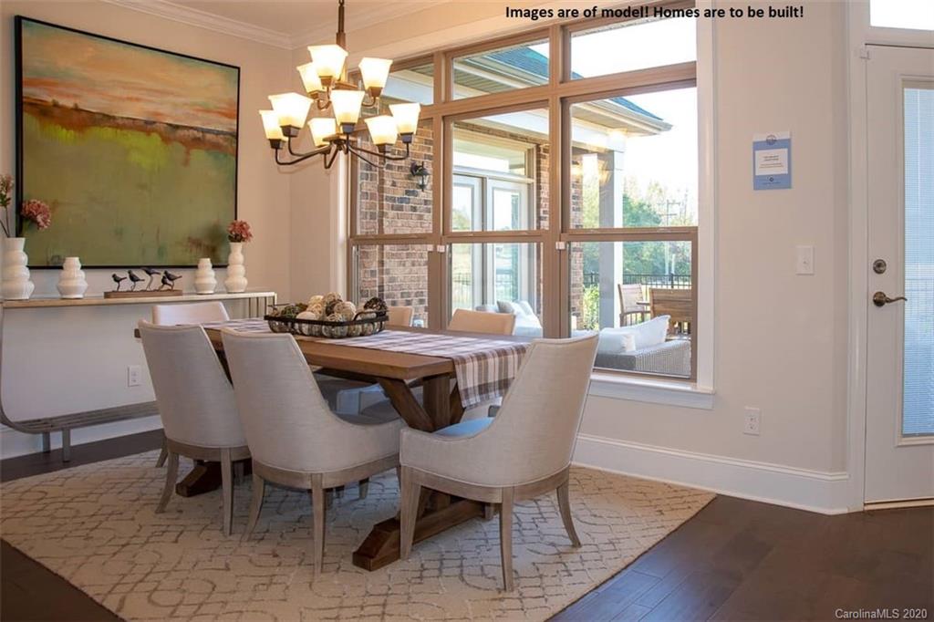 2069 New Style Way, Unit 32 Tega Cay, SC 29708 - Photo 21 of 30 a dining room with furniture a chandelier and wooden floor