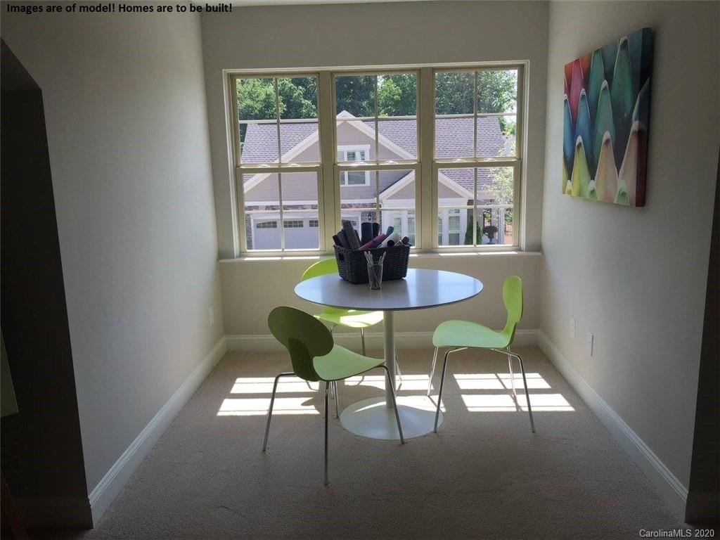 2069 New Style Way, Unit 32 Tega Cay, SC 29708 - Photo 29 of 30 a view of a dining room with furniture a rug and wooden floor