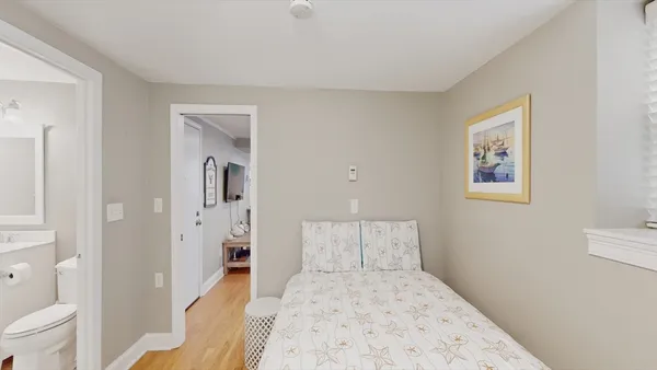 a bedroom with a bed and a view of bathroom