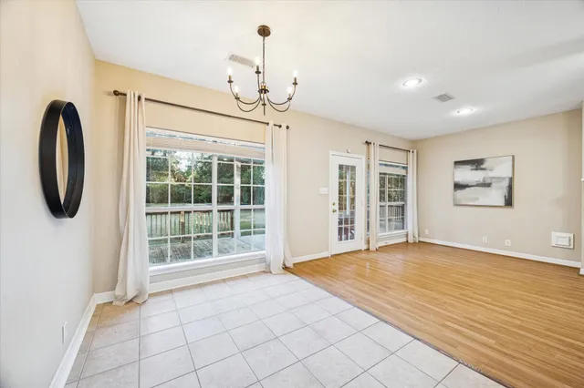 a view of an empty room with glass door