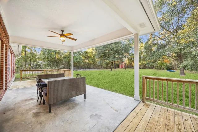 a view of a porch with furniture and garden