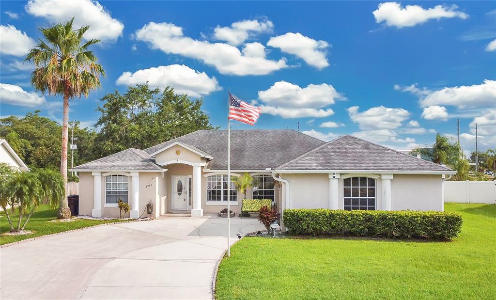 3261 Sawgrass Creek Circle St. Cloud, FL 34772 - Photo 1 of 1 a front view of a house with garden