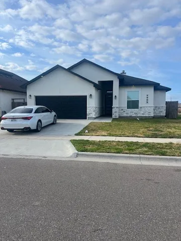 a view of garage with a car parked and a garage