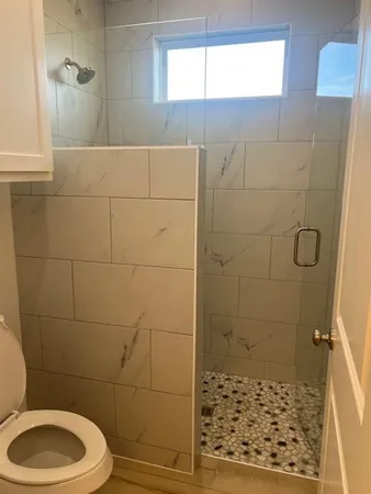 a view of a room with wooden floor and a window