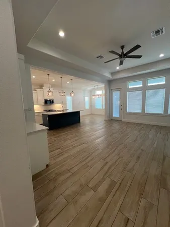a view of kitchen and hall with wooden floor