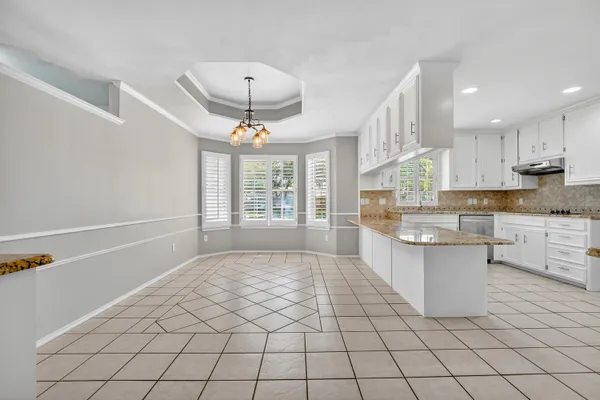 a kitchen with stainless steel appliances a sink stove and cabinets