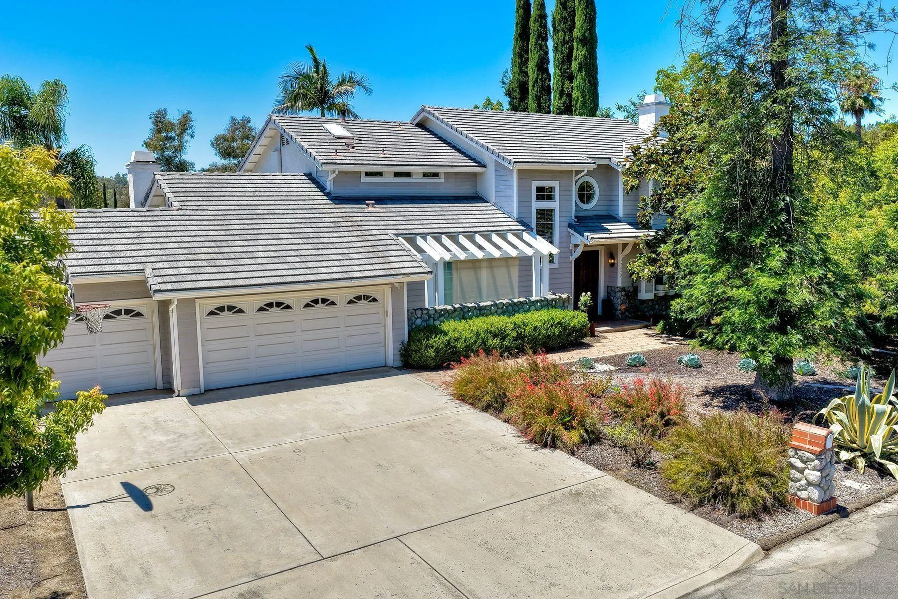 15892 Bent Tree Road Poway, CA 92064 - Photo 1 of 56 a view of a house with a yard and potted plants