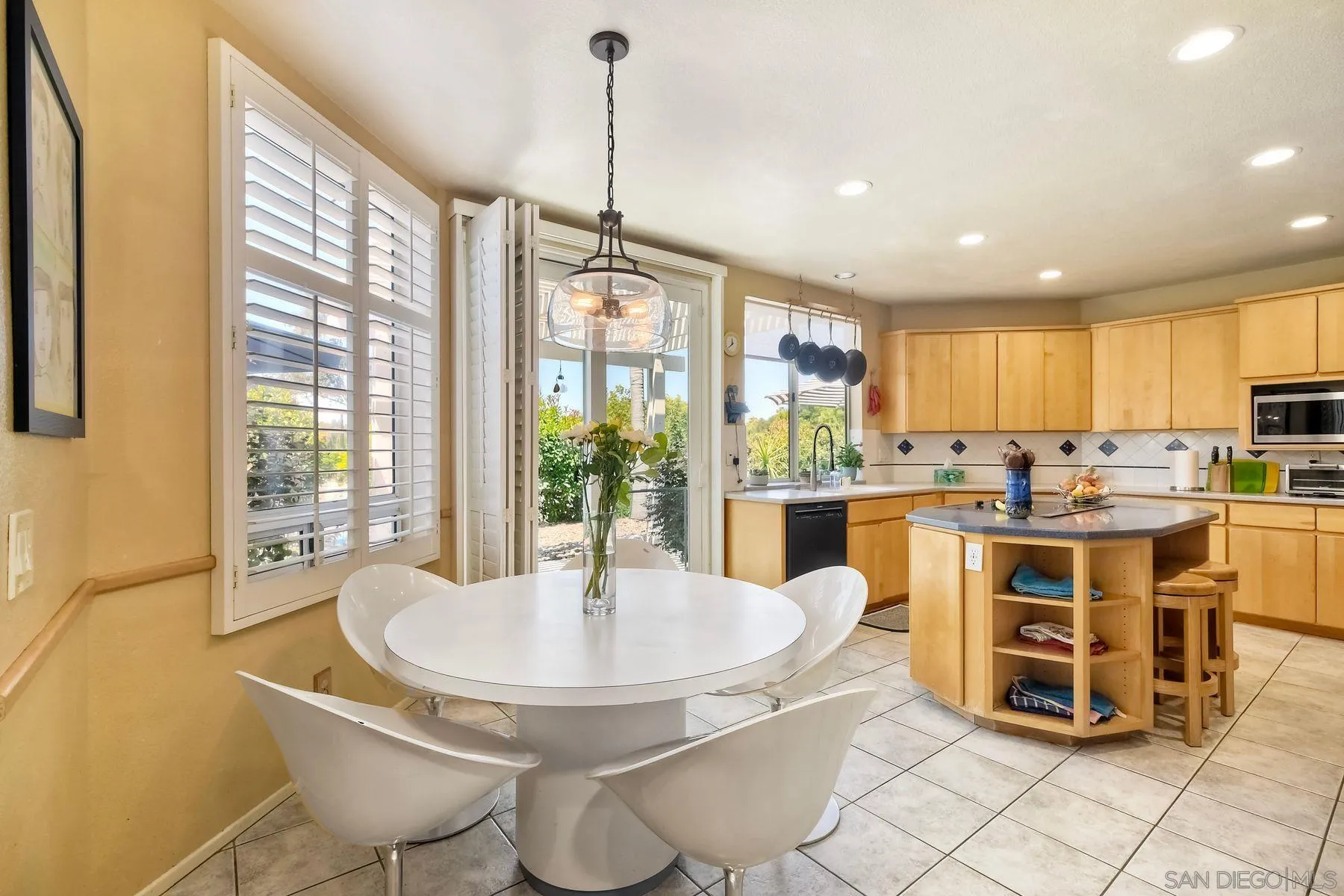 15892 Bent Tree Road Poway, CA 92064 - Photo 13 of 56 a kitchen with kitchen island a stove a table and chairs in it