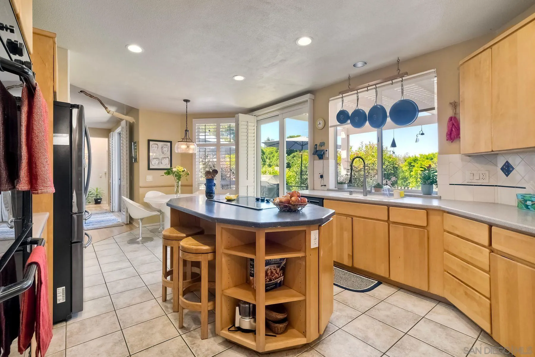 15892 Bent Tree Road Poway, CA 92064 - Photo 16 of 56 a view of a kitchen with kitchen island granite countertop a sink and cabinets