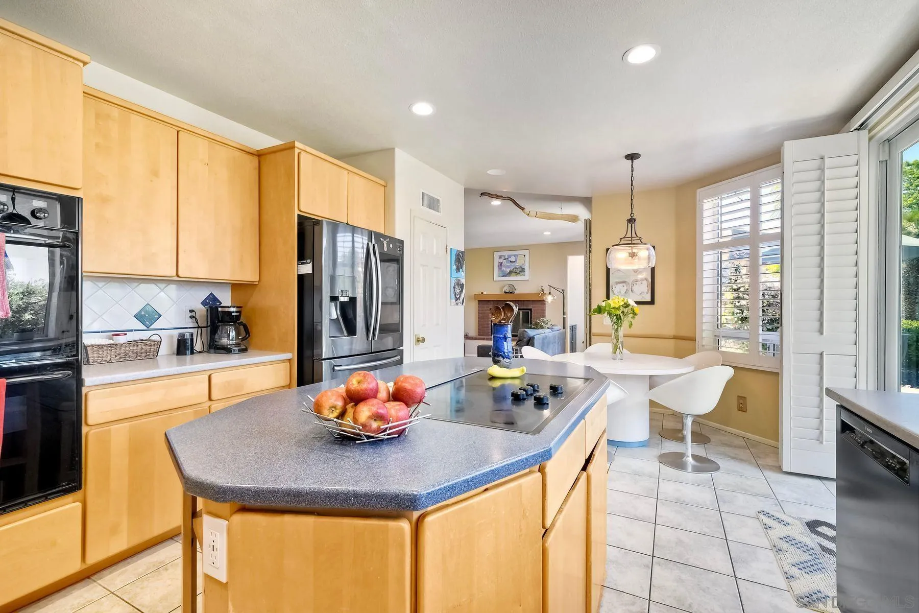 15892 Bent Tree Road Poway, CA 92064 - Photo 17 of 56 a kitchen with stainless steel appliances a table and chairs