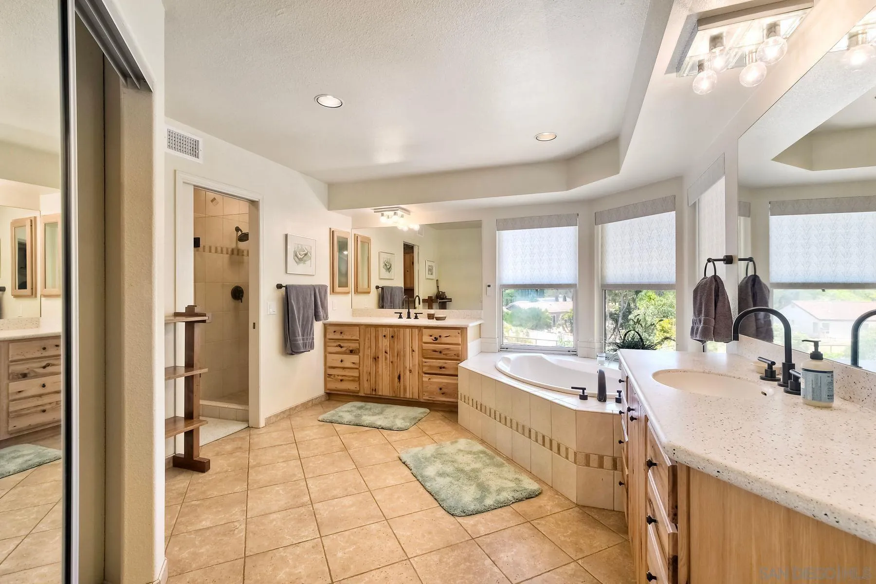 15892 Bent Tree Road Poway, CA 92064 - Photo 30 of 56 a large bathroom with a tub a double vanity sink a mirror and a shower