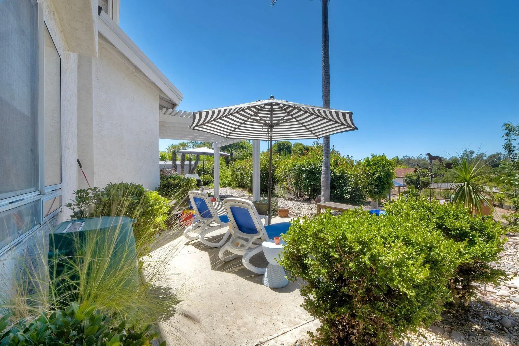 15892 Bent Tree Road Poway, CA 92064 - Photo 33 of 56 a view of a patio with chairs and potted plants