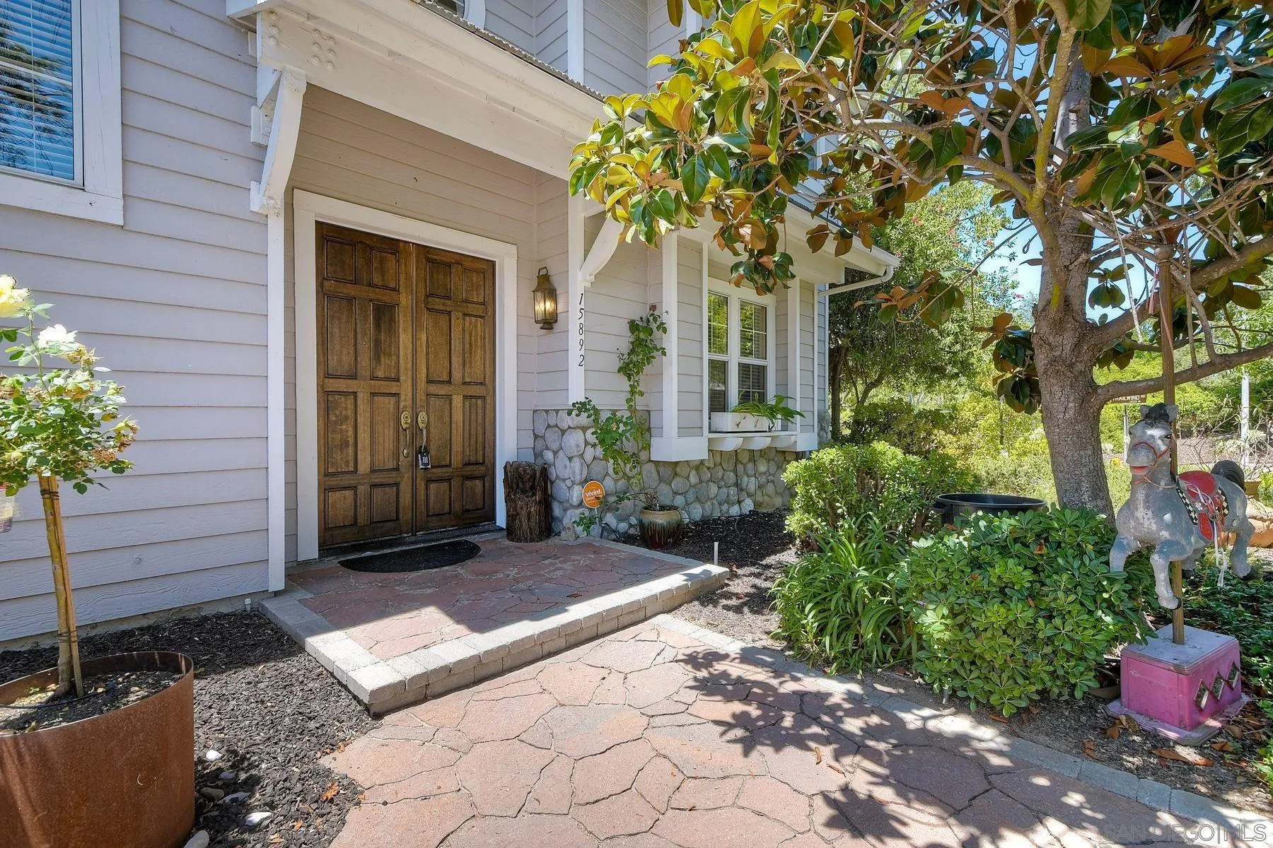 15892 Bent Tree Road Poway, CA 92064 - Photo 4 of 56 a wooden bench sitting in front of a house