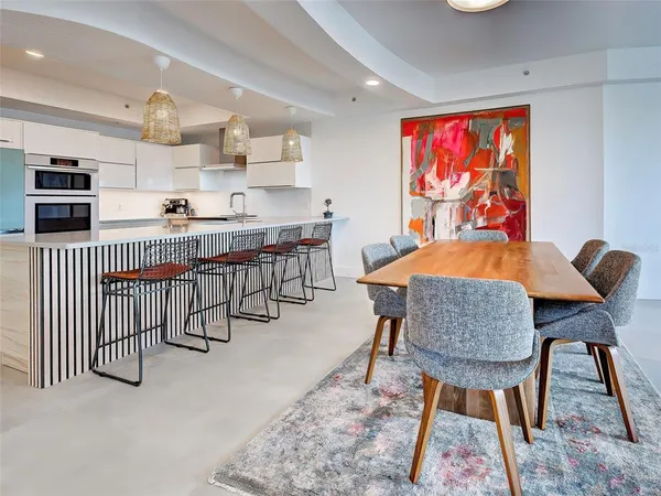 a en suite bathroom with a granite countertop tub sink and mirror