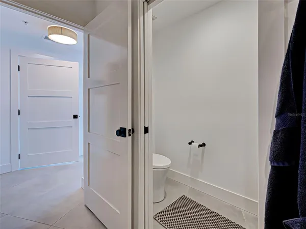 a spacious bedroom with a bed and a view of bathroom