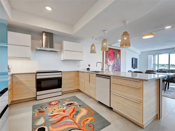 a living room with furniture a rug and a large window