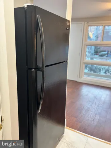 a view of a closet area with wooden floor