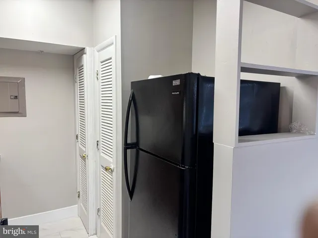 a metallic refrigerator freezer sitting in a kitchen