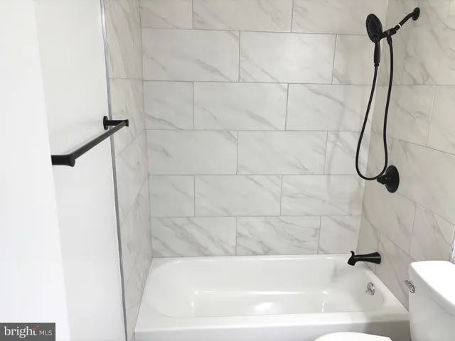 a bathroom with a bath tub with a shower