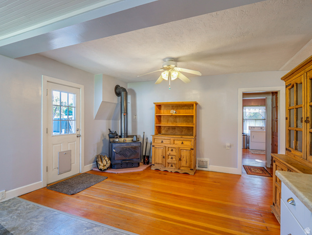 155 West Center Street Fillmore, UT 84631 - Photo 26 of 86 Hardwood flooring complements a traditional wood-burning stove with a corner hearth pad