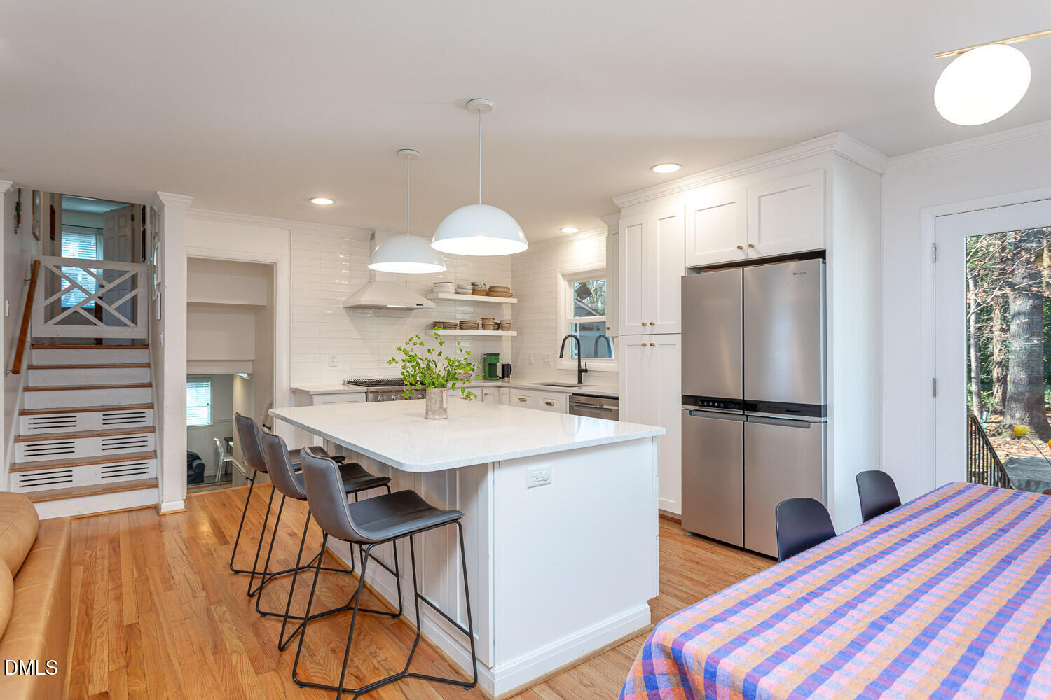 3200 Fairforest Place Raleigh, NC 27604 - Photo 11 of 40 a kitchen with stainless steel appliances a refrigerator a sink a stove a dining table and chairs with wooden floor