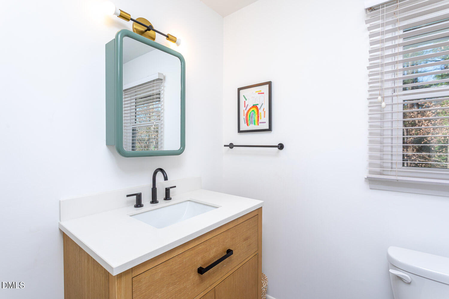 3200 Fairforest Place Raleigh, NC 27604 - Photo 16 of 40 a bathroom with a sink a mirror and a toilet