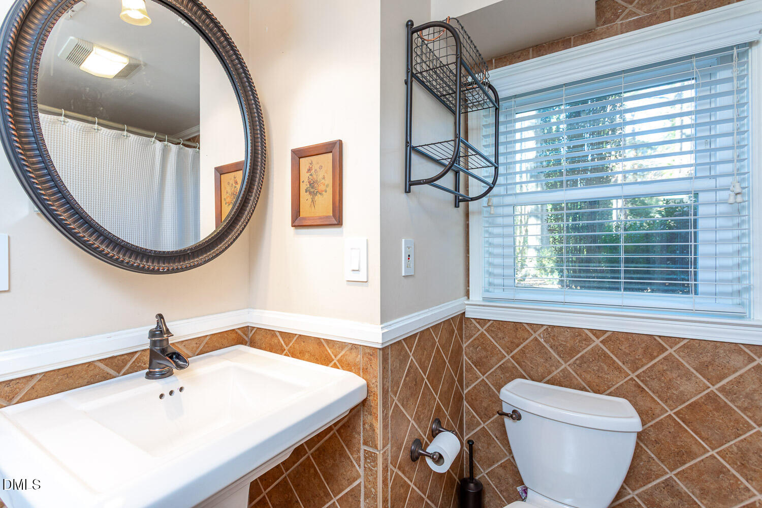 3200 Fairforest Place Raleigh, NC 27604 - Photo 24 of 40 a bathroom with a sink a mirror and a toilet