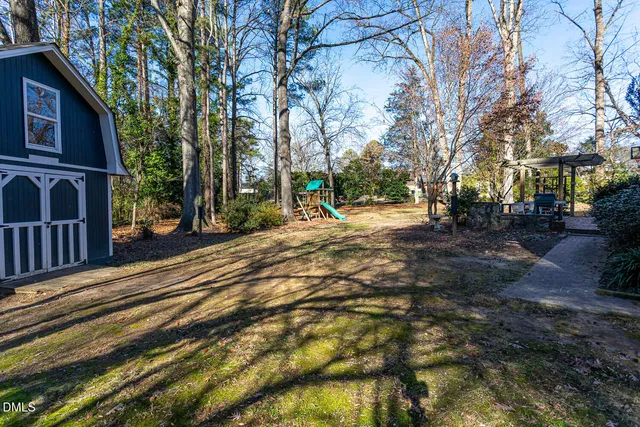 a row of palm trees in front of a house