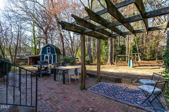 a view of a patio with couches table and chairs and potted plants