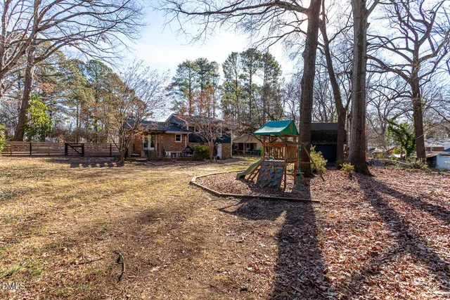 a view of a yard with a house and a tree