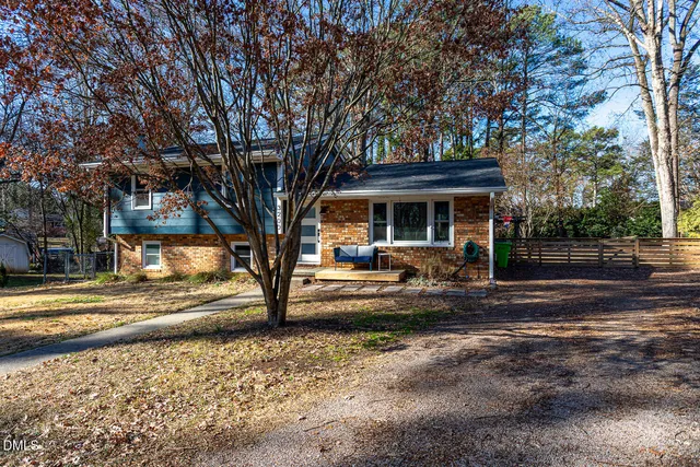 a view of a house with cars park