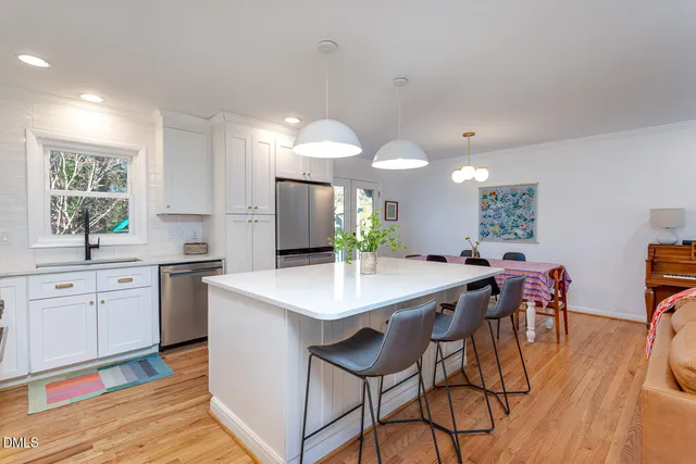 a kitchen with stainless steel appliances kitchen island a large island in the center