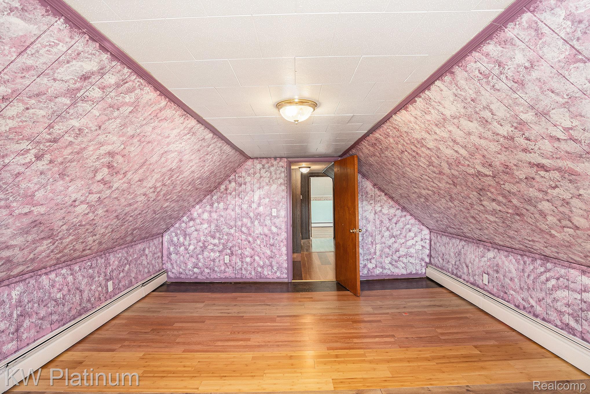8060 Brockway Road Melvin, MI 48454 - Photo 15 of 39 Bonus room featuring a baseboard heating unit, light wood finished floors, and vaulted ceiling