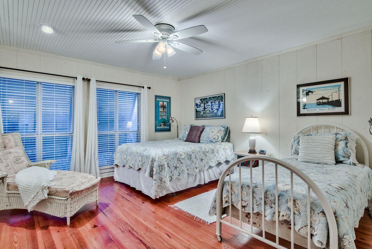 487 Blue Mountain Road Santa Rosa Beach, FL 32459 - Photo 14 of 32 a bedroom with two beds and a large mirror