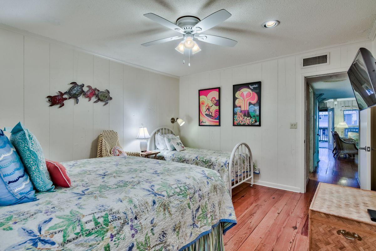 487 Blue Mountain Road Santa Rosa Beach, FL 32459 - Photo 21 of 32 a bedroom with a bed and a chandelier