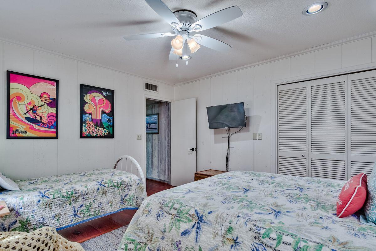 487 Blue Mountain Road Santa Rosa Beach, FL 32459 - Photo 22 of 32 a bedroom with bed and a chandelier