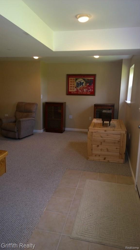 736 Fowlerville Road Fowlerville, MI 48836 - Photo 55 of 84 LL family room. ceramic entry to out of doors and the nearby firepit.