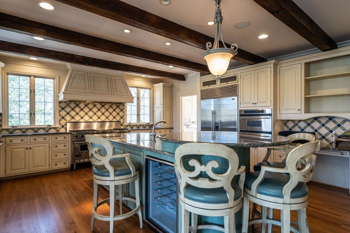 2805 Lakeview Drive Raleigh, NC 27608 - Photo 13 of 28 a kitchen with stainless steel appliances granite countertop a stove a refrigerator a oven a dining table and chairs with wooden floor