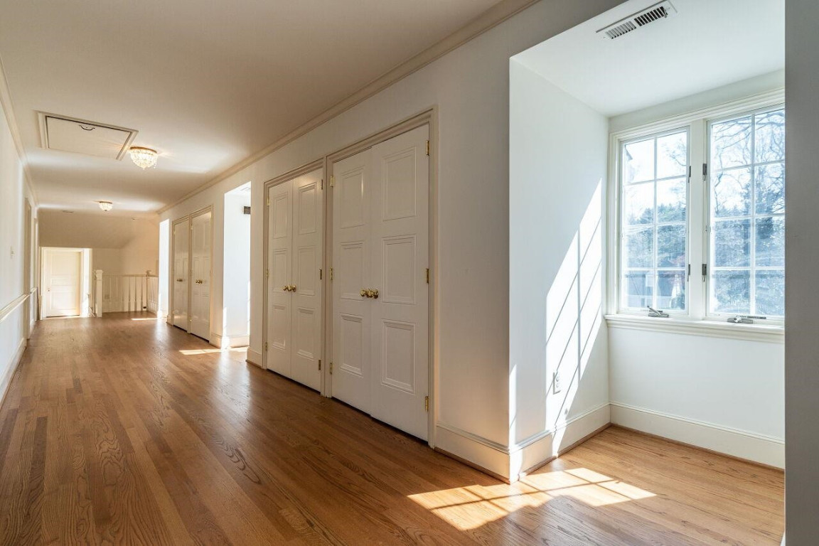 2805 Lakeview Drive Raleigh, NC 27608 - Photo 17 of 28 a view of a hallway with wooden floor and a window
