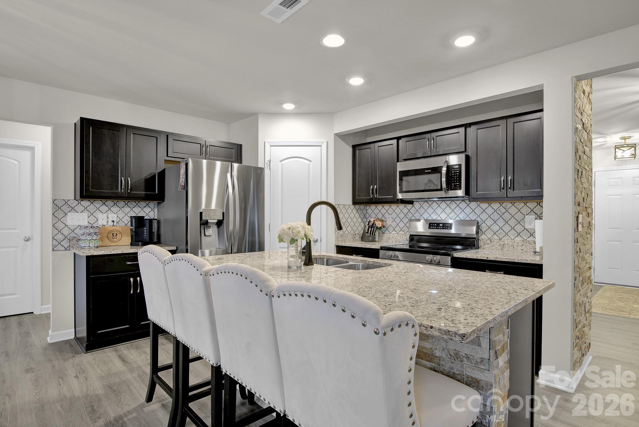 865 Old Linwood Road Lexington, NC 27292 - Photo 12 of 44 a kitchen with stainless steel appliances granite countertop a stove a sink a refrigerator a microwave and cabinets