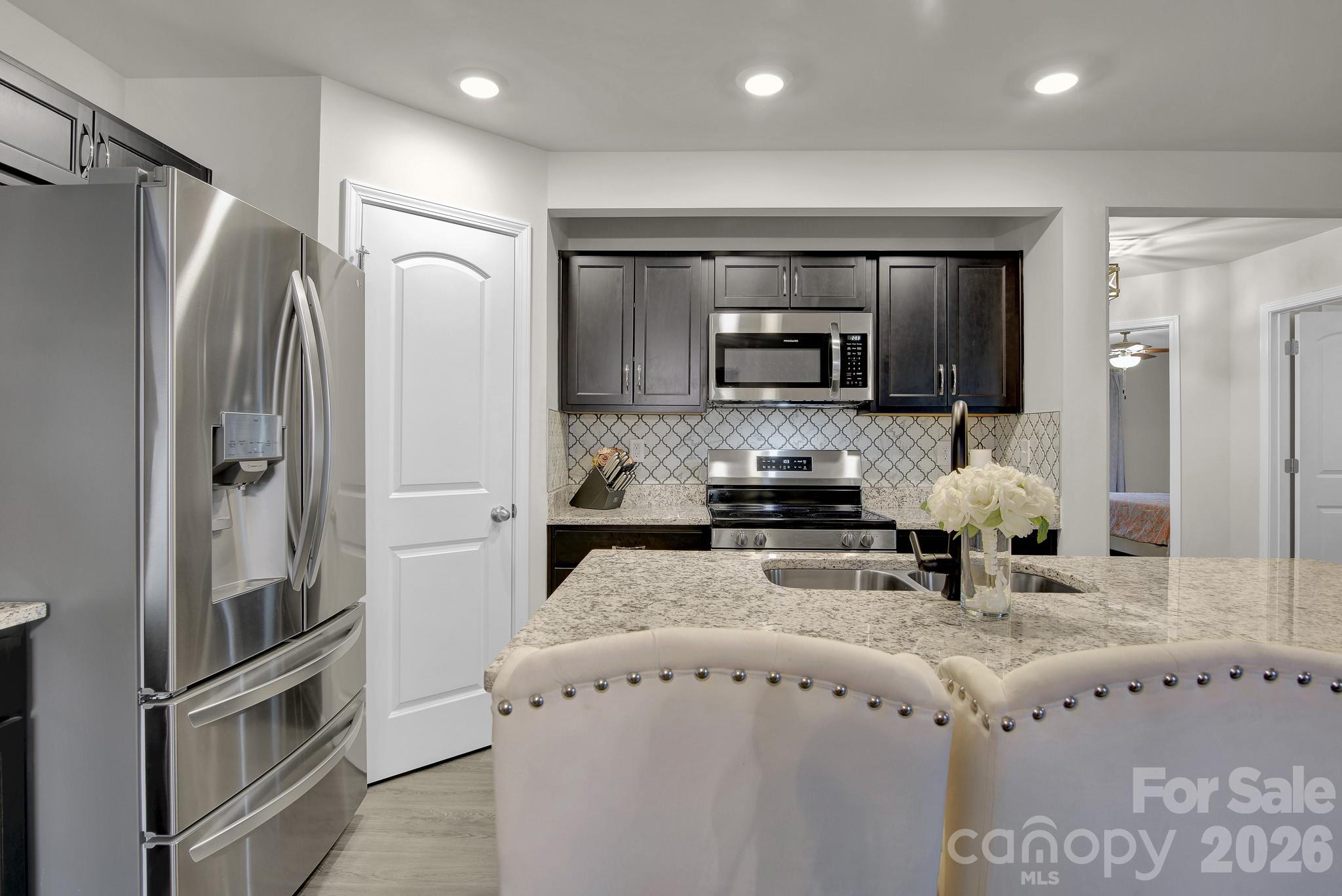865 Old Linwood Road Lexington, NC 27292 - Photo 13 of 44 a kitchen with stainless steel appliances granite countertop a refrigerator and a stove