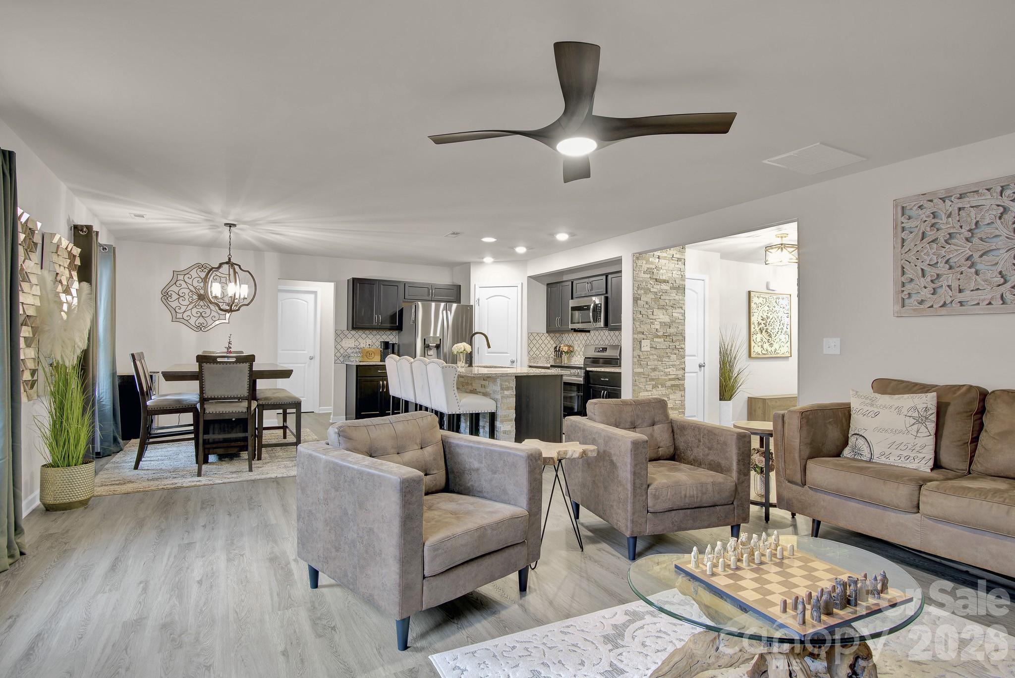 865 Old Linwood Road Lexington, NC 27292 - Photo 19 of 44 a living room with furniture kitchen view and a large window